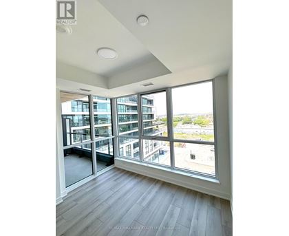 A room with a large window overlooking a cityscape.
