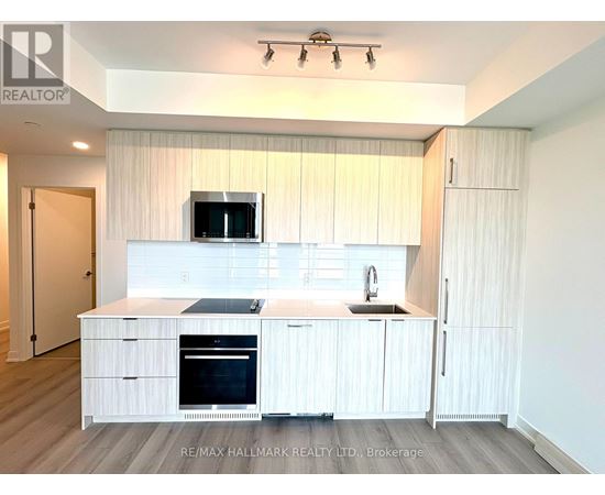 A modern kitchen with white cabinets and appliances.