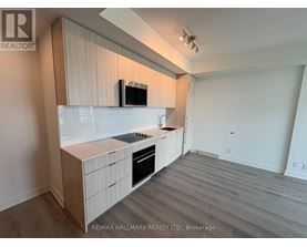 A kitchen with a microwave on the counter.