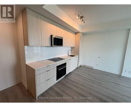 A kitchen with a microwave on the counter.