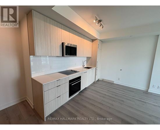 A kitchen with a microwave on the counter.