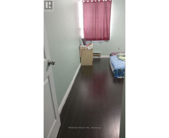 A room with a bed and a window with red curtains.