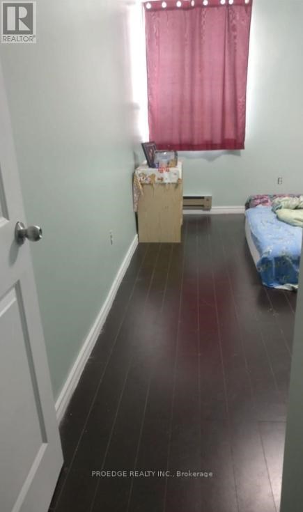 A room with a bed and a window with red curtains.
