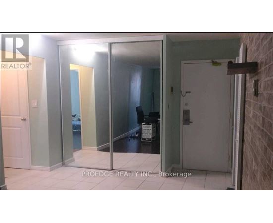 A room with a glass door and a white door.