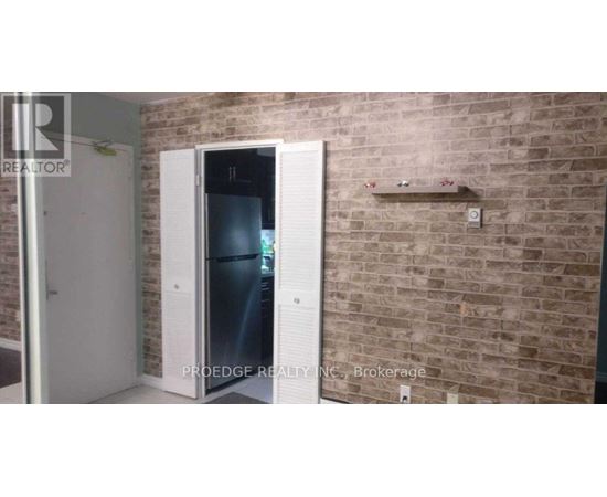 A brick wall with a white door and a small shelf above it.