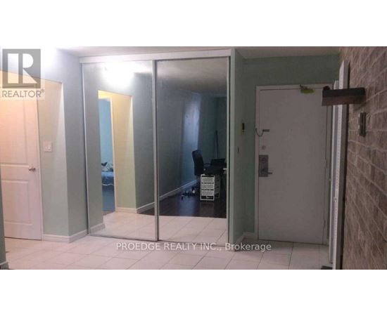 A room with a glass door and a white door.