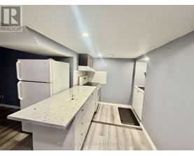 A kitchen with white appliances and a white countertop.