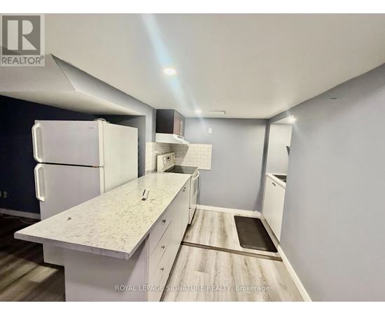 A kitchen with white appliances and a white countertop.