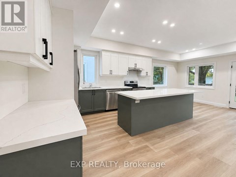 A modern kitchen with white cabinets and a large island.