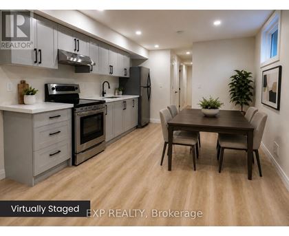 A kitchen with a table and chairs in the middle of the room.