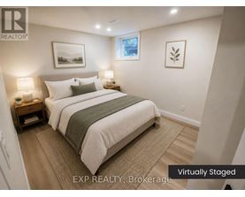 A bedroom with a bed, nightstands, and pictures on the wall.