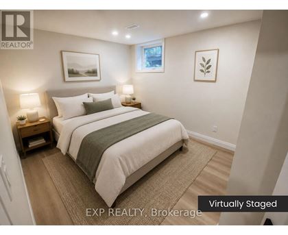 A bedroom with a bed, nightstands, and pictures on the wall.