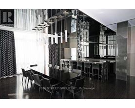 A modern dining room with a glass table and chairs.