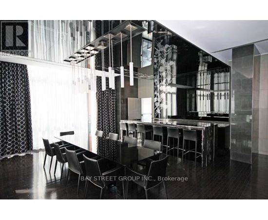 A modern dining room with a glass table and chairs.
