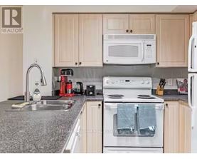 A kitchen with a white oven and a white microwave.