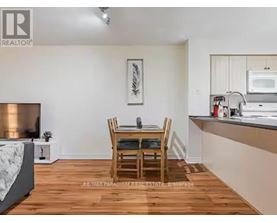 A dining room with a wooden table and chairs.