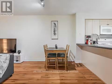 A dining room with a wooden table and chairs.