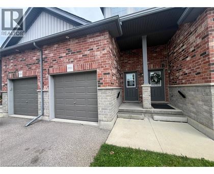 A house with a grey garage door and a black door.