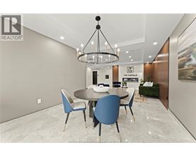 A modern dining room with a round table and chairs.