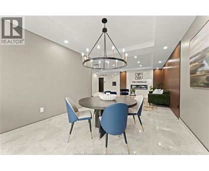 A modern dining room with a round table and chairs.
