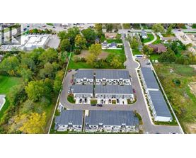 An aerial view of a large building surrounded by trees and a parking lot.