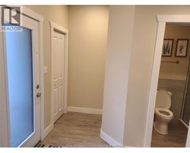 A bathroom with a toilet and a door.