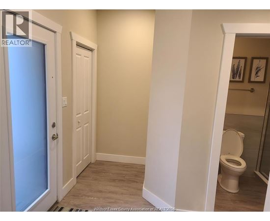 A bathroom with a toilet and a door.