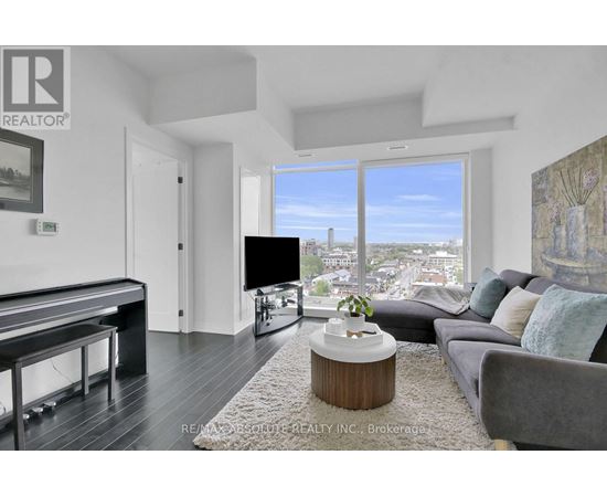 A living room with a pool table and a view of the city.
