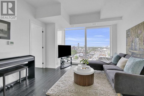 A living room with a pool table and a view of the city.