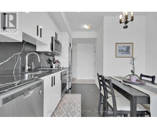 A modern kitchen with a dining table and chairs.