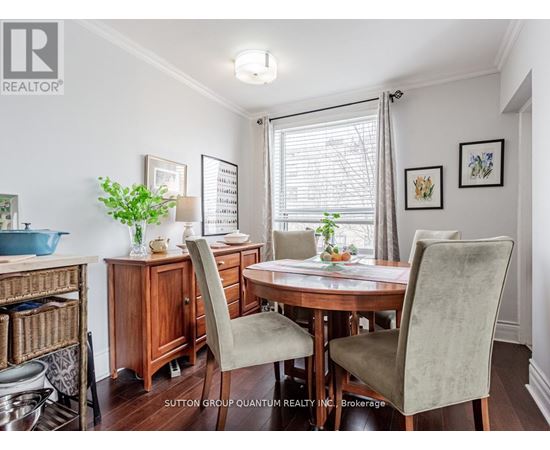 A dining room with a table and chairs.