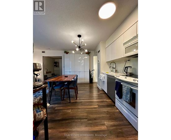 A kitchen with a table and chairs in the middle of the room.
