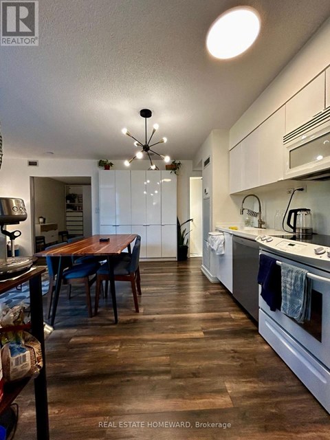 A kitchen with a table and chairs in the middle of the room.