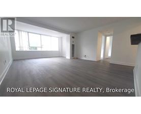 A spacious room with wooden flooring and large windows is on the market with Royal LePage Signature Realty, Brokerage.