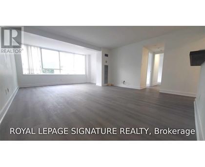 A spacious room with wooden flooring and large windows is on the market with Royal LePage Signature Realty, Brokerage.