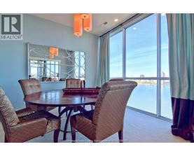 A dining room with a table and chairs.