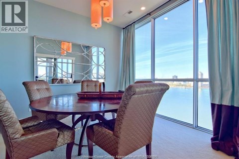 A dining room with a table and chairs.