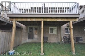 A wooden deck over a house with a white railing.