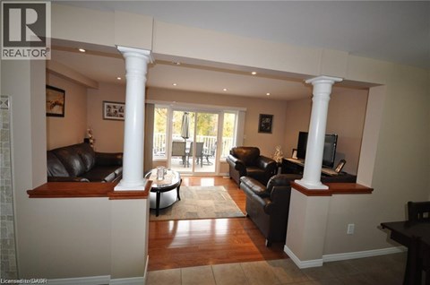 A living room with a black couch and a television.