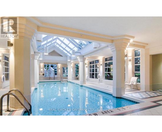 A large indoor swimming pool with a skylight above it.