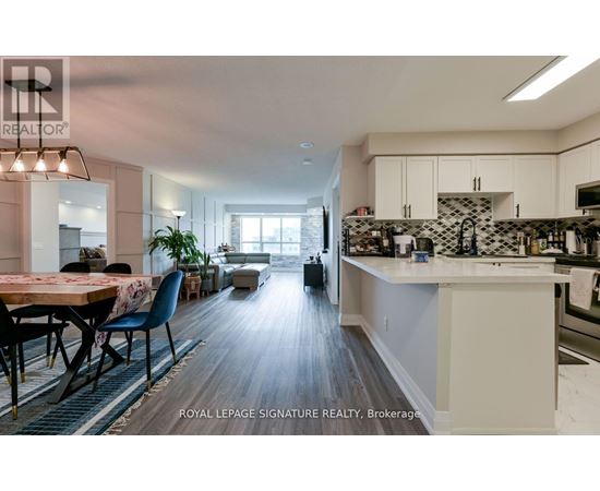 A modern kitchen with a dining table and chairs.