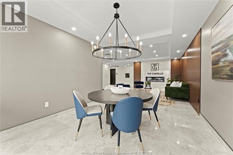 A modern dining room with a round table and chairs.