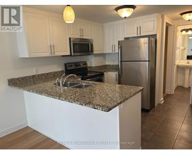 A kitchen with granite countertops and stainless steel appliances.