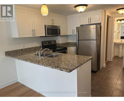 A kitchen with granite countertops and stainless steel appliances.