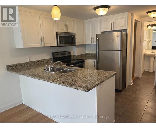 A kitchen with granite countertops and stainless steel appliances.