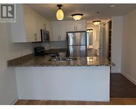 A kitchen with granite countertops and stainless steel appliances.