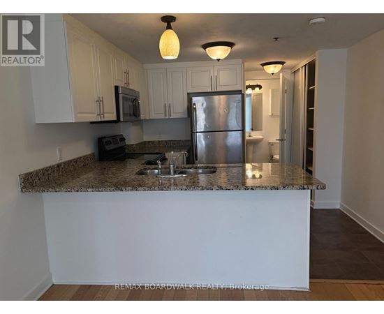A kitchen with granite countertops and stainless steel appliances.
