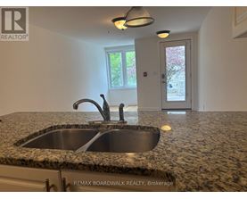 A kitchen with granite countertops and a sink.