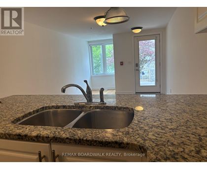A kitchen with granite countertops and a sink.