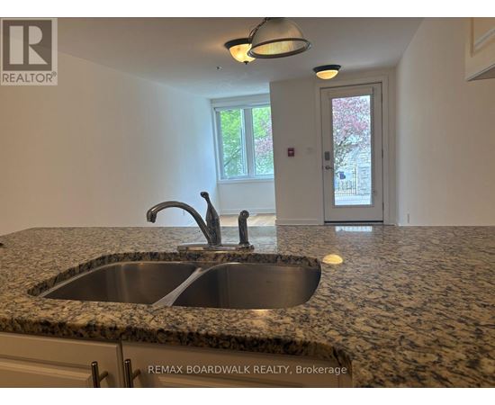 A kitchen with granite countertops and a sink.
